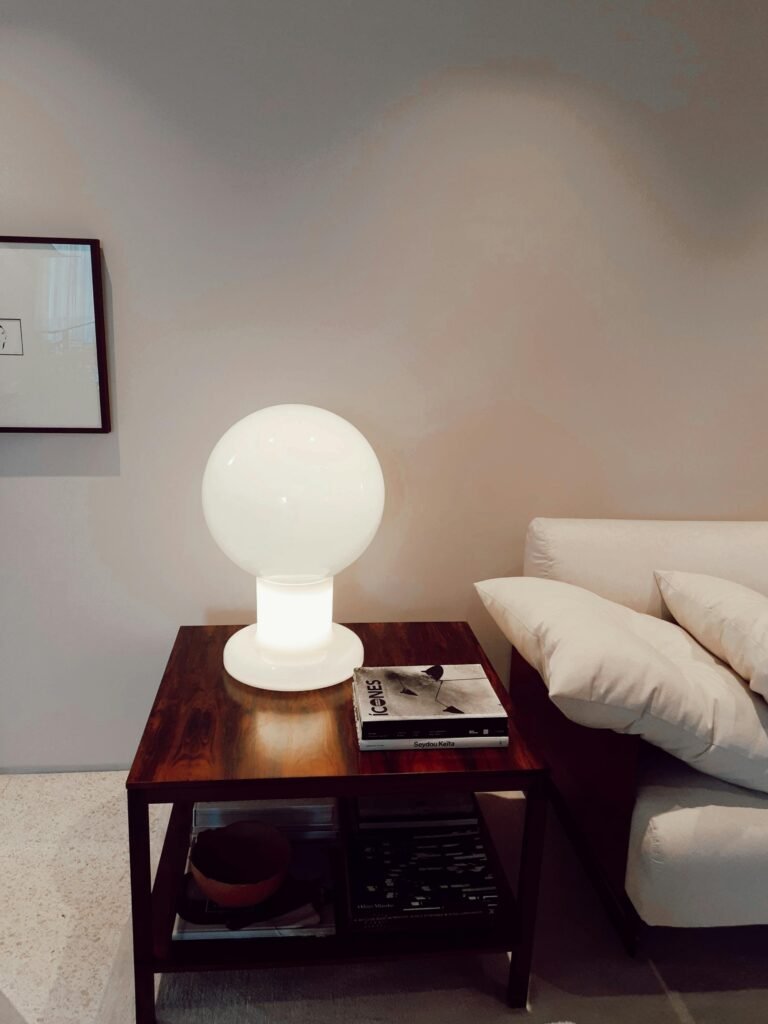 Stylish living room featuring a modern globe lamp on a wooden side table, perfect for interior design inspiration.